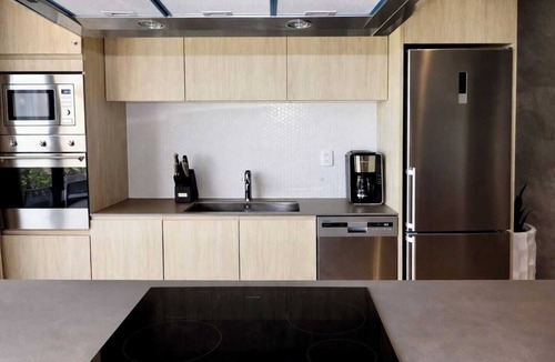 Tulum Condo | Enjoy Tulum from this comfortable 1BR apartment at TUK TULUM, ideal for up to 4 guests. It features a king bed, queen sofa bed, fully equipped kitchen, private balcony, and access to rooftop pools, paddle tennis courts, parking, and 24/7 security.