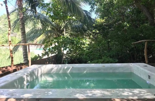 Arroyo Cruz House | Great room with deck pool in front of perfect bay