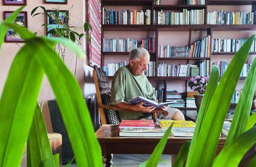 Can Tho House | Here Library - A wooden home by the river with a library