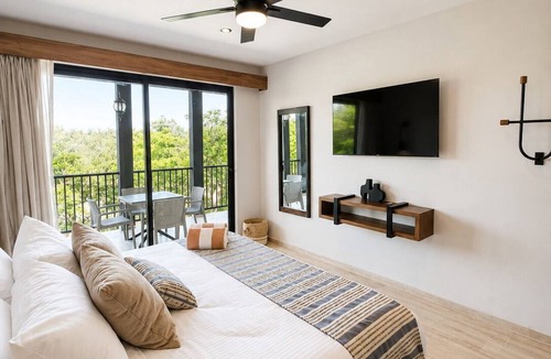 Tulum Condo | Spacious 3-bedroom condominium in Tuk Tulum, ideal for families or small groups seeking comfort, privacy, and strong amenities. Enjoy a private balcony plus access to rooftop pools, paddle court, and underground parking in a great Tulum location.
