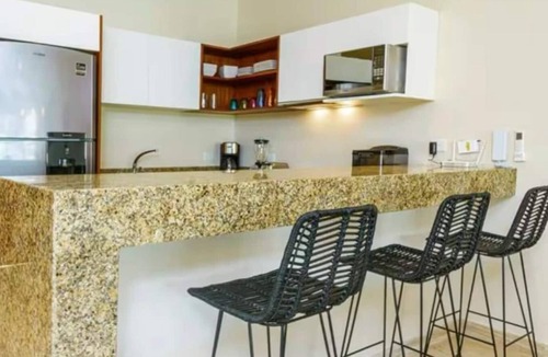 Zama Apartment | Your Tulum escape awaits. Relax in a private rooftop pool, enjoy tropical views from 3 balconies, 3 bedrooms with smart TV's, and stay minutes from beaches, cenotes, dining, and nightlife.